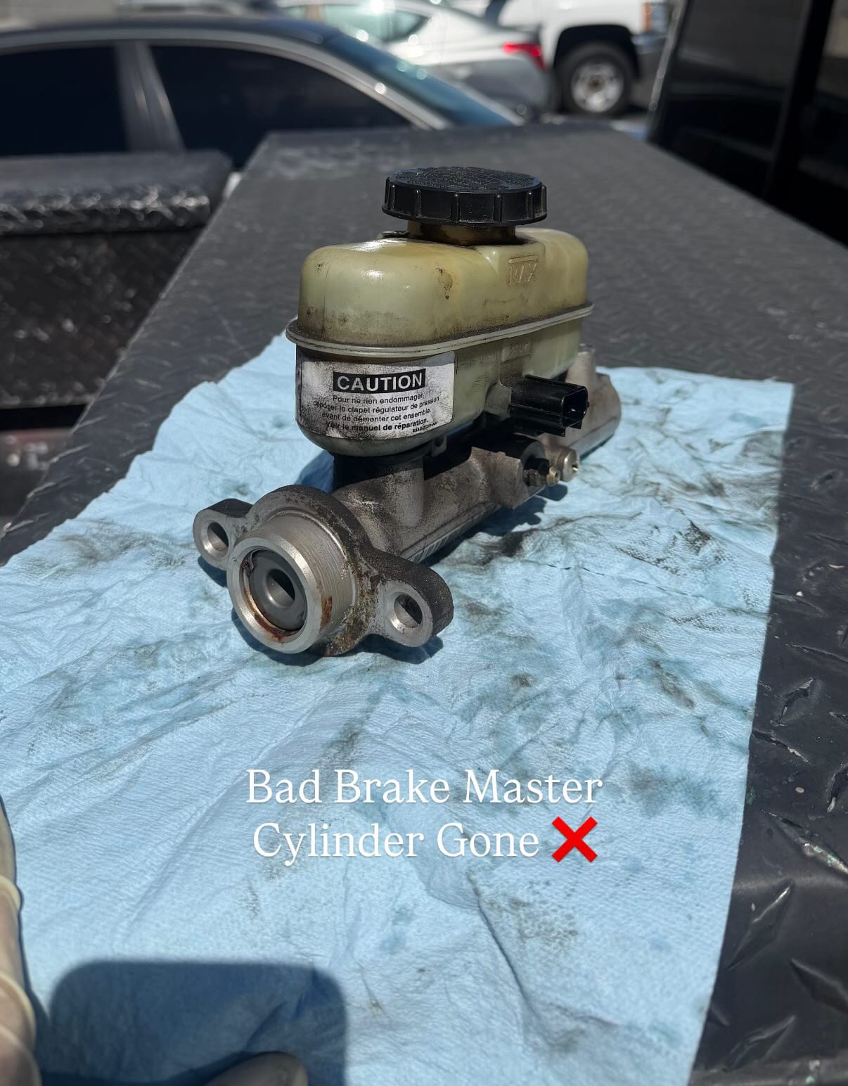 Old failing brake master cylinder removed from vehicle